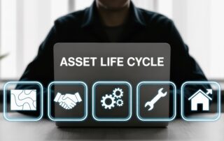 Laptop screen showing “Asset Life Cycle” with icons for planning, operations, maintenance, and disposal.